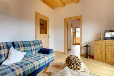 a living room with a couch and a tv at Angerle Hof in Nova Levante