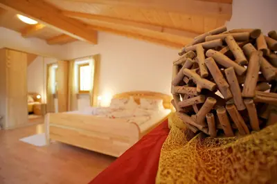 a bedroom with a bed with a basket on it at Angerle Hof in Nova Levante