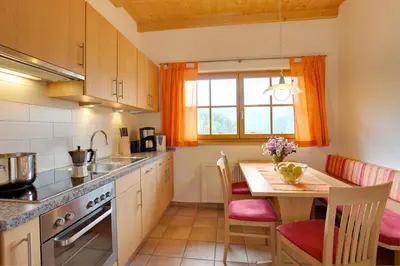 a kitchen with a table and a dining room at Angerle Hof in Nova Levante