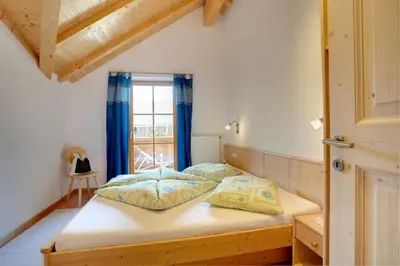 a bedroom with a bed and a window at Angerle Hof in Nova Levante
