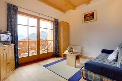 a room with a bed and a tv and a window at Angerle Hof in Nova Levante