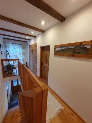 a room with a staircase with wooden floors and ceilings at Apartement Schuster Lake Prags Braies in Braies