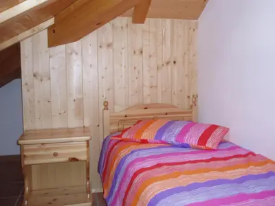 a staircase with wooden floors and a clock on the wall at Agritur Melango in Fondo