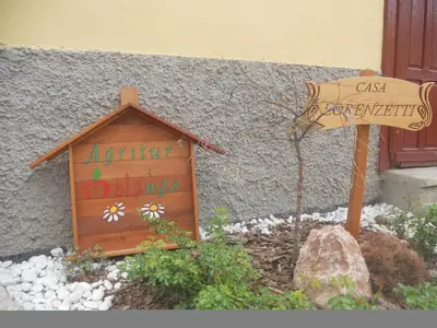 a small bedroom with a bed with a colorful comforter at Agritur Melango in Fondo