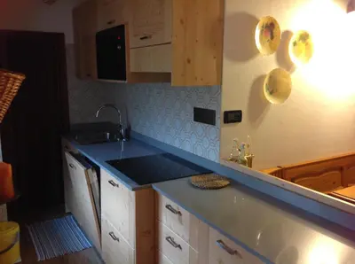 a kitchen with a blue counter top and a sink at Casa Berlanda in Fiera di Primiero