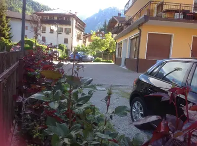 a car parked in a driveway next to a building at Casa Berlanda in Fiera di Primiero