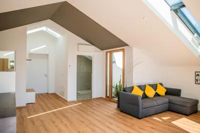 a living room with a gray couch and yellow pillows at Villa Camilde - elegance and relax in Merano in Merano