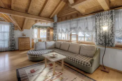 a living room with a couch and a table at Alexander Mountain-Lodge in San Vigilio Di Marebbe