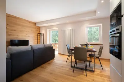 a living room with a couch and a table at SnowLake Suite & Apartment in Alleghe