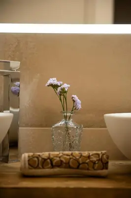 a vase with flowers in it sitting on a table at SnowLake Suite & Apartment in Alleghe