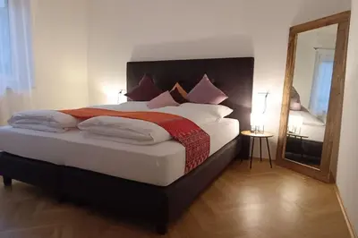 a bedroom with a large bed with a large mirror at Apartment Alpenflair City Meran in Merano