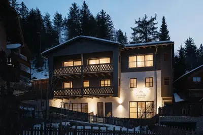 a large house with a balcony on the side of it at Pescosta Chalet Luxury Living in San Vigilio Di Marebbe