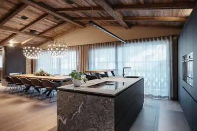 a kitchen and dining room with a table and chairs at Pescosta Chalet Luxury Living in San Vigilio Di Marebbe