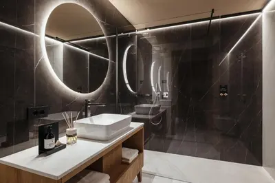 a bathroom with a sink and a mirror at Pescosta Chalet Luxury Living in San Vigilio Di Marebbe