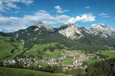 a town in a valley with mountains in the background at Pescosta Chalet Luxury Living in San Vigilio Di Marebbe