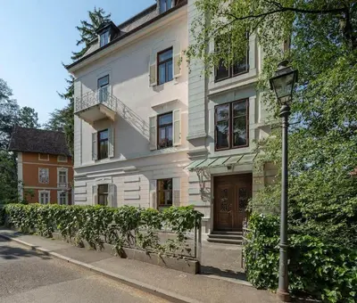 a white building with a street light in front of it at Apartment Anna in Merano