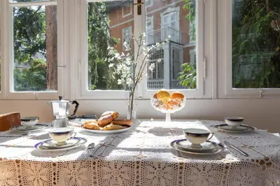 a table with a white table cloth with food on it at Apartment Anna in Merano