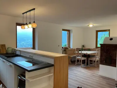 a kitchen with a counter and a dining room at Apartments Stroblhof in Ortisei