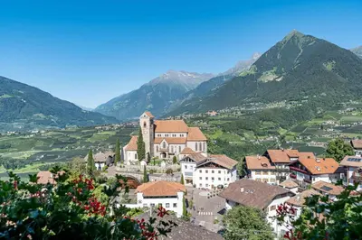 a town in a valley with mountains in the background at Garni Dürrenstein in Schenna