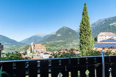 a view of a town with mountains in the background at Garni Dürrenstein in Schenna