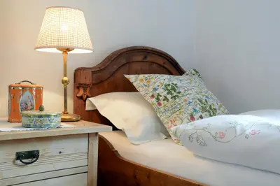 a bedroom with a bed with a lamp and pillows at APARTMENT im garten 9 in Gargazzone