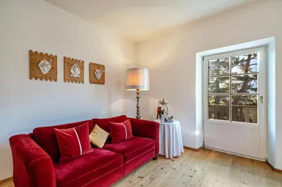 a red couch in a living room with a window at APARTMENT im garten 9 in Gargazzone