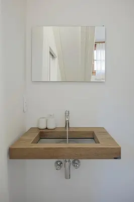 a bathroom with a sink and a mirror at Historic Rooms and Apartments in the City Centre of Bolzano in Bolzano