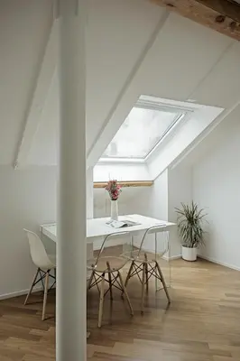 a dining room with a white table and a skylight at Historic Rooms and Apartments in the City Centre of Bolzano in Bolzano