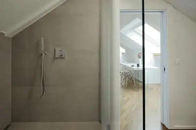 a bathroom with a shower with a glass door at Historic Rooms and Apartments in the City Centre of Bolzano in Bolzano