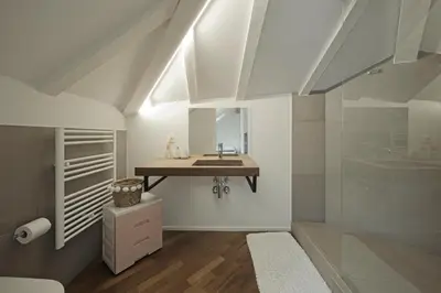 a bathroom with a sink and a mirror at Historic Rooms and Apartments in the City Centre of Bolzano in Bolzano