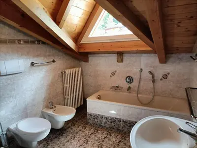a kitchen with white cabinets and a microwave at Appartamenti Villa Maria in Canazei