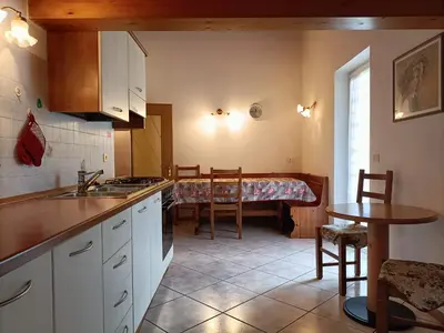 a bedroom with a bed and a window at Appartamenti Villa Maria in Canazei