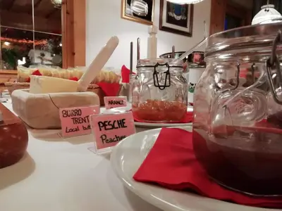 a table with a counter top with food in jars at Rifugio Capanna Passo Valles in Falcade