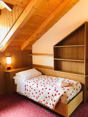 a bedroom with a bed with red hearts on it at Rifugio Capanna Passo Valles in Falcade