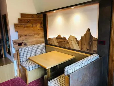 a dining room with a table and two chairs at Rifugio Capanna Passo Valles in Falcade