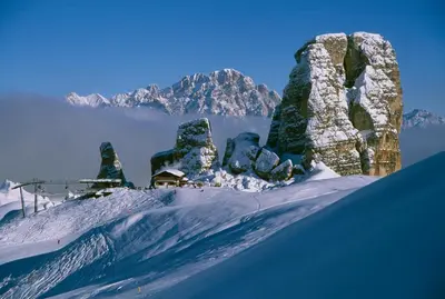 a snow covered mountain with a house on a ski slope at Ciasa Vervei in Cortina dʼAmpezzo