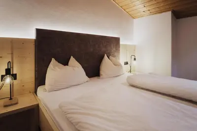 a bedroom with two beds with white pillows at Töllhof Studio Stube in Bressanone