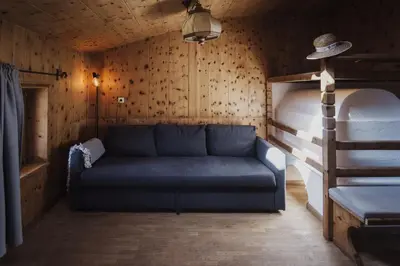 a living room with a couch and a bunk bed at Töllhof Studio Stube in Bressanone