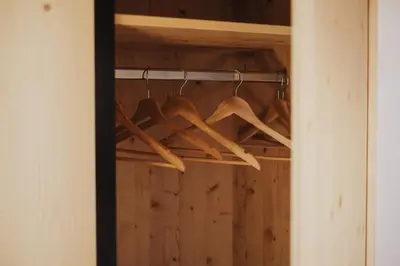 a bunch of wooden hangers in a closet at Töllhof Studio Stube in Bressanone