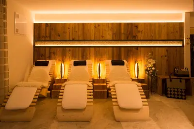 a room with a row of chairs and lights at Apartments Antines in Selva di Val Gardena