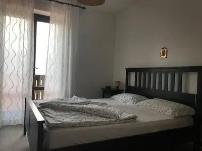 a large bed in a bedroom with a window at Casa Corgol con vista lago e montagne in Predaia