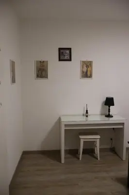 a white desk with a lamp and a stool at Casa Corgol con vista lago e montagne in Predaia