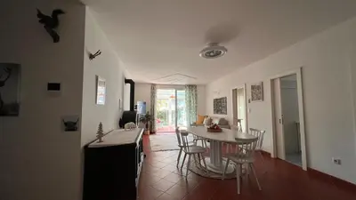 a kitchen and dining room with a table and chairs at Garden Suite in Bolzano