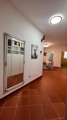 a room with a large glass door and a tile floor at Garden Suite in Bolzano