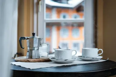 a table with two tea cups and a coffee pot at Ciasa Gianot in Moena