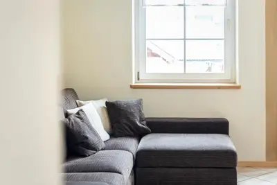 a couch in a living room with a window at Ciasa Gianot in Moena