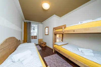 two bunk beds in a room with a window at Ciasa Gianot in Moena