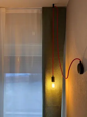 a light on a wall next to a window at Villa Ginestra - 1 in Moena