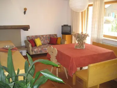 a wooden staircase in a living room with a ceiling at Appartamenti Decrestina in Campitello di Fassa