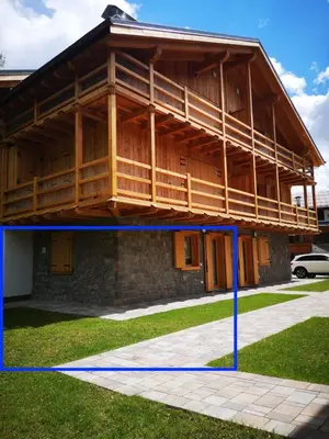 a house under construction with a blue tape around it at Falcade Lodge in Falcade